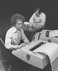 An old photo of a man using a primitive computer