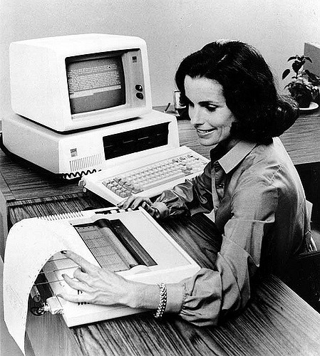 A woman typing on a typewriter